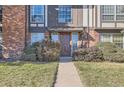 Charming front entry with a well-maintained lawn and path leading to the front door at 3855 S Monaco St # 209, Denver, CO 80237