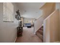 Bright entryway leading into a cozy living area with neutral tones and carpeted floors at 9800 Mayfair St # E, Englewood, CO 80112
