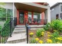 Inviting front porch with seating and well-maintained landscaping leading to the entrance at 2868 Kingston St, Denver, CO 80238