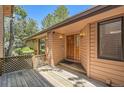 Inviting entryway with wood door, and decorative sconces, and wooden deck at 7500 E Dartmouth Ave # 22, Denver, CO 80231