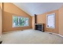 Cozy living room with large windows, a brick fireplace, and neutral carpeting at 7500 E Dartmouth Ave # 22, Denver, CO 80231