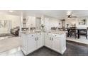 Open-concept kitchen featuring a large island with granite countertops and modern finishes at 6184 Clayton St, Frederick, CO 80530