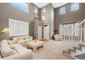 Bright living room with soaring ceilings and lots of windows at 10633 Wynspire Way, Highlands Ranch, CO 80130