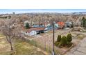 Aerial view of a home surrounded by trees and other colorful houses, offering a unique perspective of the property at 11640 W 13Th Ave, Lakewood, CO 80401