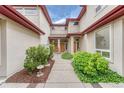 Elegant home with a welcoming entrance, featuring lush greenery and unique architectural elements at 980 S Locust St # D, Denver, CO 80224