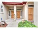 Close-up of the front doors, showcasing classic design, natural wood finish, and decorative accents at 980 S Locust St # D, Denver, CO 80224