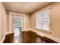 Inviting bedroom with hardwood floors, trim detail, and bright windows at 1365 Clayton St, Denver, CO 80206