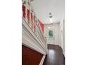 Elegant entryway featuring a staircase with white banisters, hardwood floors, and a bright, welcoming ambiance at 1365 Clayton St, Denver, CO 80206