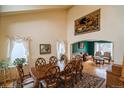 Elegant dining room featuring a large table, decorative tapestry, and an archway leading to a cozy sitting area at 2829 S Fig St, Lakewood, CO 80228
