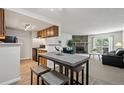 Open floorplan living room showing dining area, fireplace, and connection to kitchen at 943 S Zeno Way # 102, Aurora, CO 80017