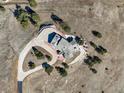 An aerial view showcasing the expansive property, surrounding greenery, and a lengthy driveway leading to the home at 156 S Lookout Mountain Rd, Golden, CO 80401
