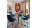 Cozy dining area with a glass-top table, stylish blue chairs, and access to outdoor deck at 156 S Lookout Mountain Rd, Golden, CO 80401
