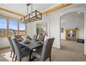 Bright dining room with mountain views, modern chandelier, and adjacent butler's pantry at 156 S Lookout Mountain Rd, Golden, CO 80401