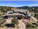 Stunning home featuring a stone driveway, mature trees, and a roof with multiple dormers and a stone chimney at 156 S Lookout Mountain Rd, Golden, CO 80401