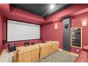 Home theater with projector screen, plush seating, and dark, sound-insulated walls at 156 S Lookout Mountain Rd, Golden, CO 80401