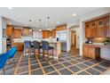 Open kitchen featuring a large island with bar seating, granite countertops, and stainless steel appliances at 156 S Lookout Mountain Rd, Golden, CO 80401