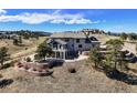 View of the home's rear exterior highlighting a large patio, balconies, and well-manicured landscaping at 156 S Lookout Mountain Rd, Golden, CO 80401