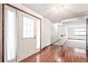 Welcoming entryway with hardwood floors, a white front door, and access to other living spaces at 9431 W Jewell Pl, Lakewood, CO 80227