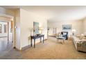 Inviting living room featuring neutral carpet, stylish furniture, and a view into the dining area at 4631 Ashfield Dr, Boulder, CO 80301