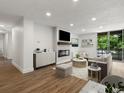 Staged living room with sleek fireplace, balcony access, and modern decor at 2500 S York St # 204, Denver, CO 80210