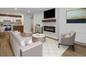 Bright living room with modern fireplace, mounted TV, and open floor plan at 2500 S York St # 204, Denver, CO 80210