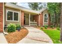 Inviting brick and tan home featuring a cozy front porch and a well-manicured walkway at 19165 Golden Arrow Cir, Monument, CO 80132