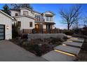 Stylish two-story home with inviting illuminated walkway and thoughtfully designed landscaping offering privacy at 815 E Westglow Ln, Greenwood Village, CO 80121