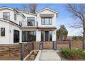 Handsome modern house with black windows, horizontal wood slat fence, and a welcoming entry at 815 E Westglow Ln, Greenwood Village, CO 80121