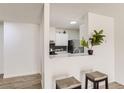 Modern kitchen with white cabinets, stainless steel appliances, backsplash, and a convenient breakfast bar, great for entertaining at 2281 S Vaughn Way # 214A, Aurora, CO 80014