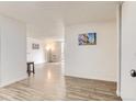 The bright living room has light wood floors, neutral walls, and a sliding glass door to the balcony, leading to the entryway at 2281 S Vaughn Way # 214A, Aurora, CO 80014