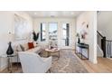 Bright living room with modern decor, including a comfortable sofa, stylish rug, and ample natural light at 22 Oneida Ct, Denver, CO 80230