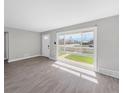 Updated living room with large window, fresh paint, and new flooring at 795 Moline St, Aurora, CO 80010