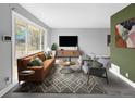 Bright living room featuring large windows, modern decor, and comfortable seating area, perfect for relaxation and entertainment at 795 Moline St, Aurora, CO 80010