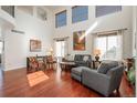 Bright living room with hardwood floors, high ceilings, large windows and contemporary furnishings at 3211 Westbrook Ln, Highlands Ranch, CO 80129