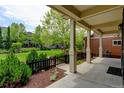 Covered front porch with sturdy pillars and an attractive view of the landscaped front yard at 5080 Uinta St, Denver, CO 80238