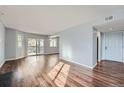 Spacious living area with gleaming hardwood floors, natural light, and balcony access for scenic views at 17652 E Loyola Dr # 2032R, Aurora, CO 80013