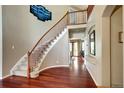 Elegant foyer with hardwood floors, staircase, and views leading into other rooms at 8720 E 163Rd Pl, Brighton, CO 80602