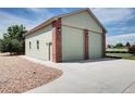 Detached two-car garage with brick accents, matching the main home's exterior design at 8720 E 163Rd Pl, Brighton, CO 80602