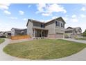 Attractive two-story home with stone accents, well-kept lawn, and inviting front porch at 603 Jewel St, Brighton, CO 80603