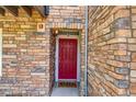 The unit's front door features brick accents and a welcome mat at 2763 W Riverwalk Cir # B, Littleton, CO 80123