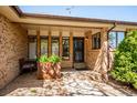 Inviting front porch area with stylish brickwork, decorative plants, and a cozy seating space at 2615 Oak Dr # 7, Lakewood, CO 80215