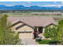 A cozy house showcasing a three-car garage, with a stunning mountain view at 4965 Bierstadt Loop, Broomfield, CO 80023