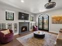 Bright living room with fireplace, built-in cabinets, and access to outdoor living at 4495 Utica St, Denver, CO 80212