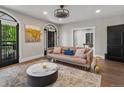 Inviting living room boasting a decorative light fixture, hardwood floors, and large window at 4495 Utica St, Denver, CO 80212