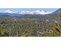 Scenic mountain view showcasing a beautiful landscape filled with lush forest and snow-capped peaks at 2817 Keystone Dr, Evergreen, CO 80439