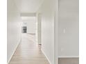 Bright hallway featuring sleek flooring leading to a light-filled room with a sliding glass door at 1918 S Coolidge Way, Aurora, CO 80018