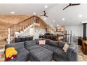 Open-concept living space with wood accents and a large gray sectional sofa at 302 Texas Dr, Idaho Springs, CO 80452