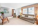 Cozy living room featuring neutral walls, plush sofa and recliner near bright windows, creating a warm and inviting atmosphere at 10321 E Evans Ave # 171, Aurora, CO 80247