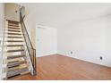 Light-filled living room features hardwood floors and staircase at 8975 Field St # 39, Broomfield, CO 80021