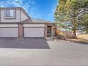 Charming townhome showcasing a well-maintained front yard, two-car garage and inviting front entry at 6321 S Harrison Ct, Centennial, CO 80121